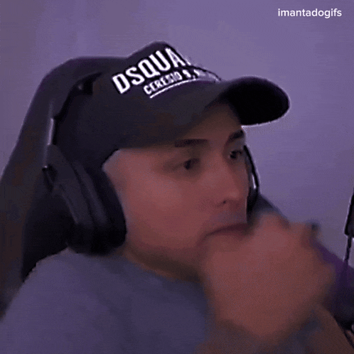 a man wearing headphones and a hat that says dsquir on it