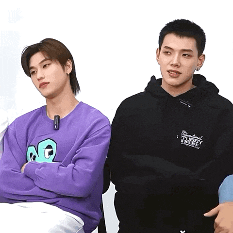a man wearing a purple sweater and a man wearing a black hoodie