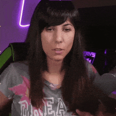 a woman wearing a shirt that says ea looks at the camera