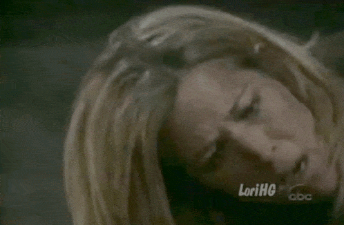 a close up of a woman 's face with lorihg written on the bottom right
