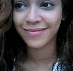 a close up of a woman 's face without makeup smiling .