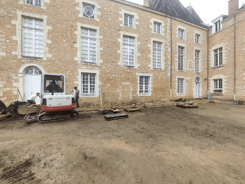 a white bulldozer is parked in front of a building