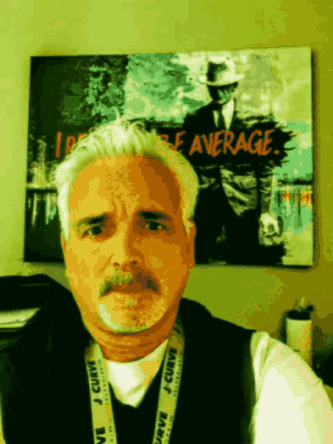 a man stands in front of a painting that says average on it