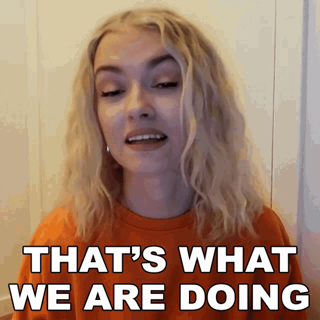 a woman says that 's what we are doing while wearing an orange shirt