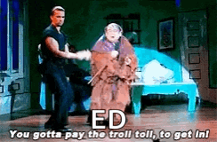 a man and a woman are dancing on a stage with the words `` ed you gotta pay the troll toll to get in ! ''