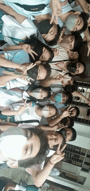 a group of people are posing for a picture with one wearing a mask