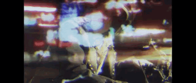 a blurry picture of a person standing in front of a blurred background