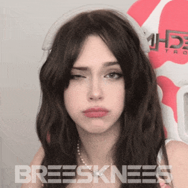 a woman wearing headphones with the word breesknees written on the bottom