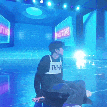 a person wearing a shirt with the letters thi-0 on it