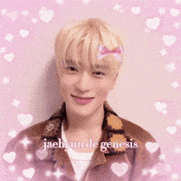 a young man is making a heart shape with his hands .