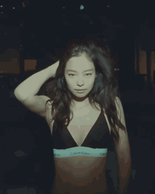 a woman wearing a calvin klein bra looks at the camera