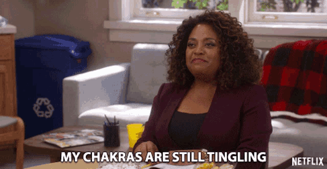 a woman sitting on a couch says " my chakras are still tingling " on netflix
