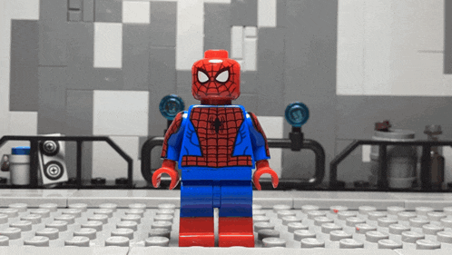 a lego figure of spider-man stands on a keyboard