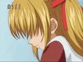 a girl with blonde hair and a red bow in her hair is being shown on a tv screen