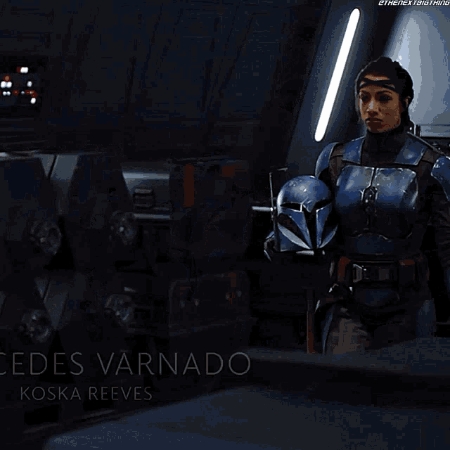 a close up of a woman in a blue armor with the name elden varnado