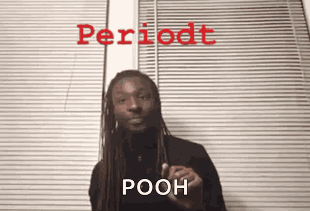 a man with dreadlocks is standing in front of a window with blinds and says periodt pooh in red letters
