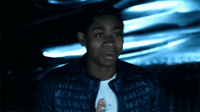 a young man wearing a black jacket and a white t-shirt with a cartoon spongebob on it