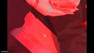 a close up of a person 's arm with a red light behind it