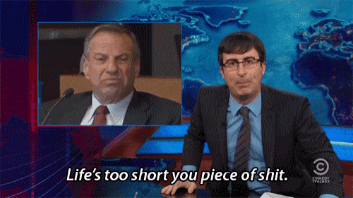 a man in a suit says life 's too short you piece of shit while another man looks on