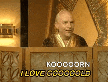 a man in a robe is standing behind a podium and saying koooooorn i love gogoold