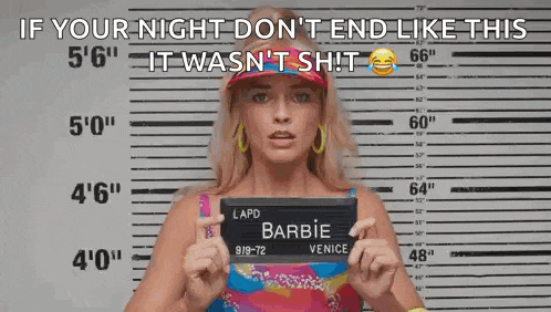 a woman is holding a mug shot of herself in front of a police line up .