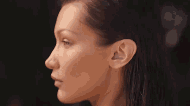 a close up of a woman 's face with her eyes closed