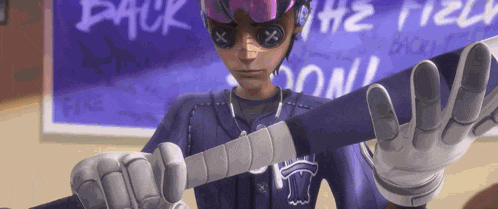 a man in a purple baseball uniform is holding a baseball bat in his hands .