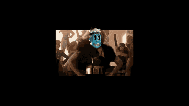 a woman with a skull on her face is dancing in front of a crowd