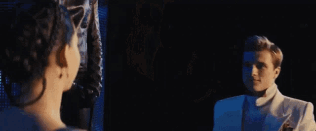 a man and woman are dancing together in a dark room .