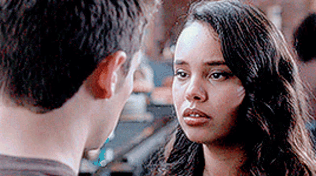 a man and a woman are looking into each other 's eyes .