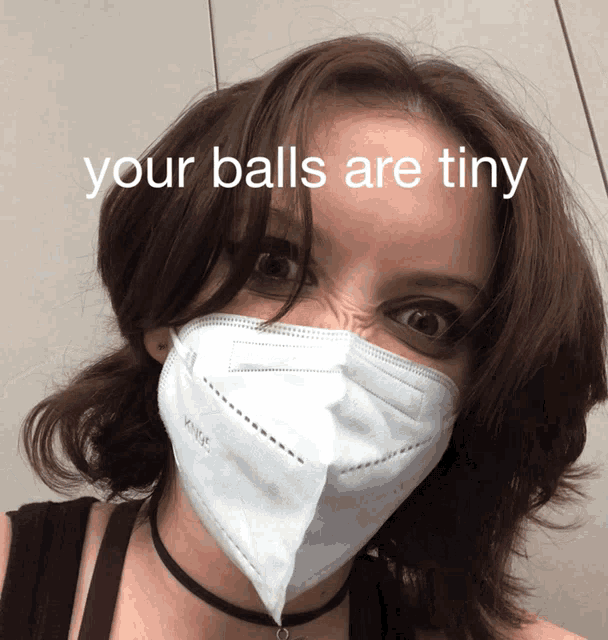 a woman wearing a face mask with the words your balls are tiny written above her