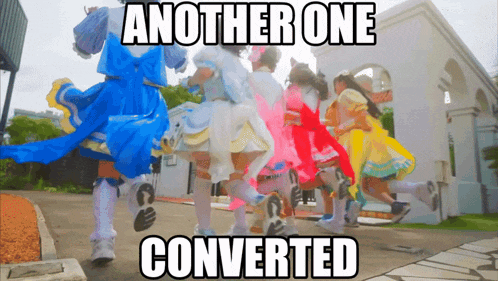 a group of girls in colorful dresses are walking in front of a building with the caption another one converted