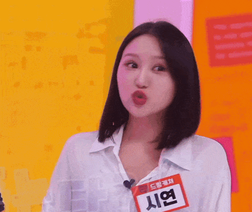 a woman with a name tag that says ' 시연 ' on it making a funny face