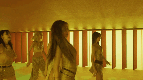 a group of women are dancing together in a room