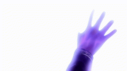 a person 's hand is reaching out in front of a bottle of lotion