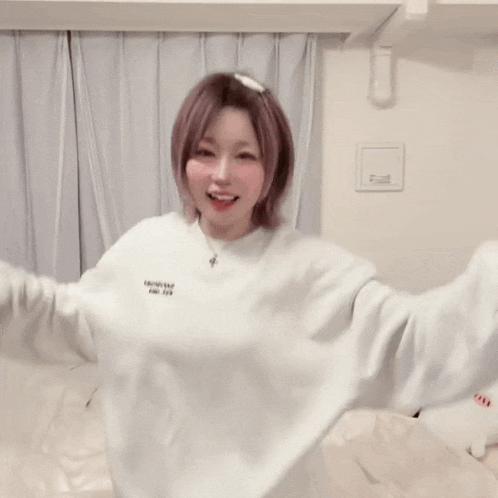 a woman is wearing a white sweatshirt that says ' tokyo ' on it