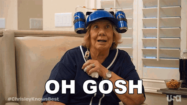 an elderly woman wearing a blue hat with beer cans on it says oh gosh