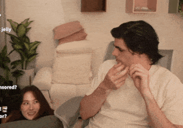 a man and a woman are sitting on a couch with jelly written on the bottom of the screen