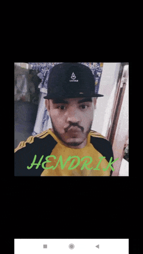 a man wearing a hat and a yellow shirt with the name hendrik on the bottom