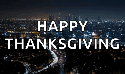 a picture of a city at night with the words happy thanksgiving in the foreground