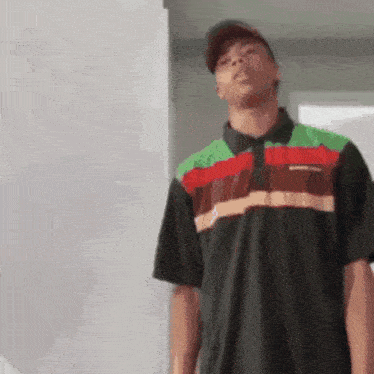 a man wearing a burger king polo shirt is standing in a room