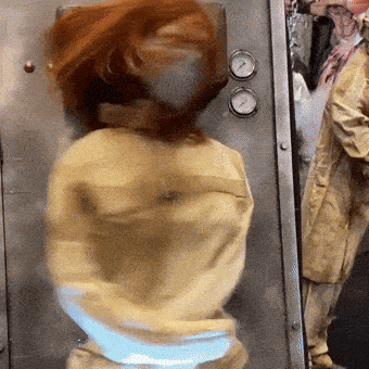 a blurred image of a woman in a yellow jacket