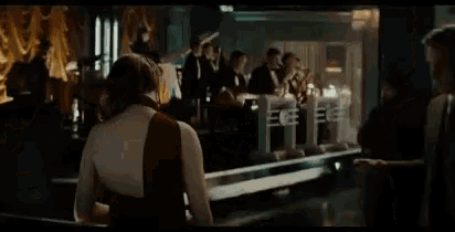 a woman in a red dress is standing in front of a bar
