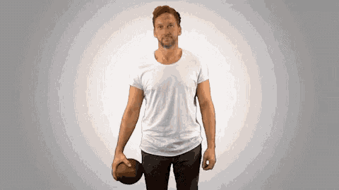a man in a white shirt holds a football