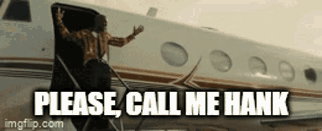 a man standing in front of an airplane with the words " please call me hank "