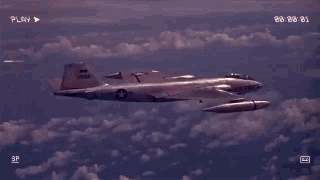 a video of a fighter jet flying in the sky with the play button at the bottom