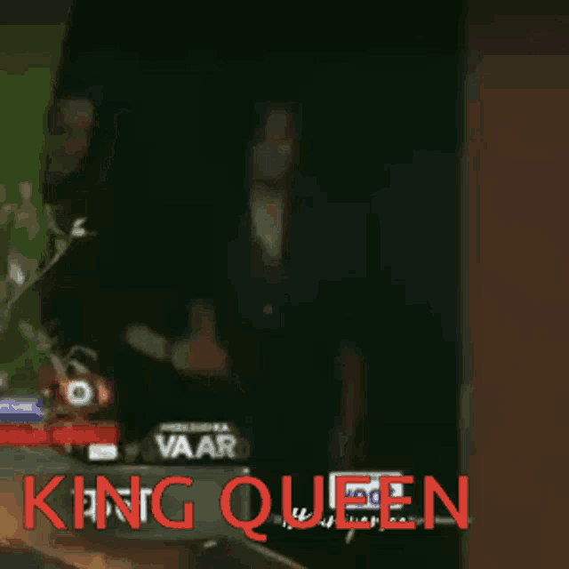 a king queen sign with a blurred image of two people