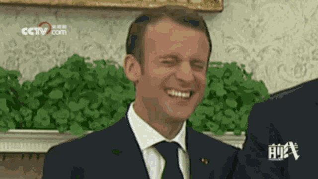 a man in a suit and tie is making a funny face