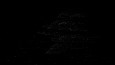 a cross that is glowing in the dark with smoke coming out of it