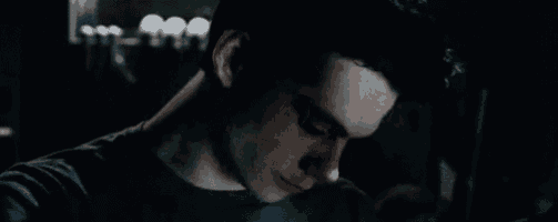 a close up of a man 's face in the dark .